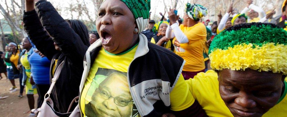 Supporter of Jacob Zuma raising her fist