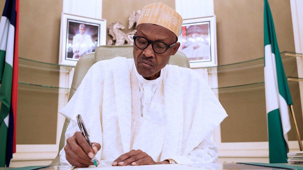 Nigeria"s President Muhammadu Buhari signs the instrument of ratification of the Paris Agreement on climate change in Abuja, Nigeria March 28, 2017.