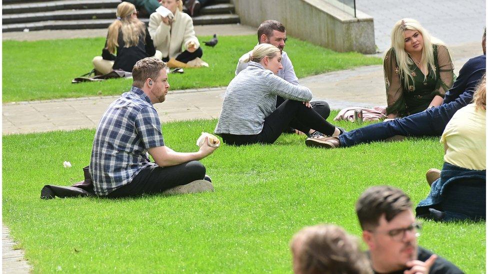 People enjoying the sun in Belfast's Botanic Park