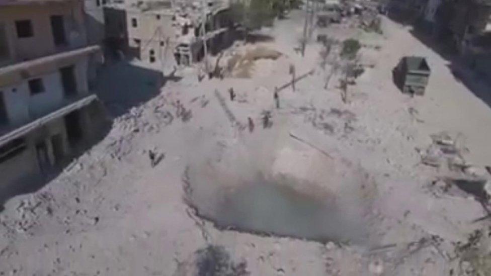 Crater left by bomb which hit Finnish-Syrian Association HQ in Aleppo