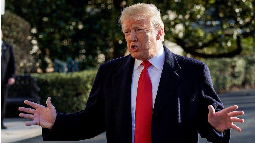 US President Donald Trump speaks to the media as he departs for Camp David from the White House in Washington