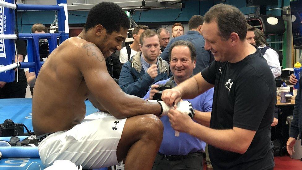 Joshua having the bandages removed from his hands at his pre-fight media day in Sheffield