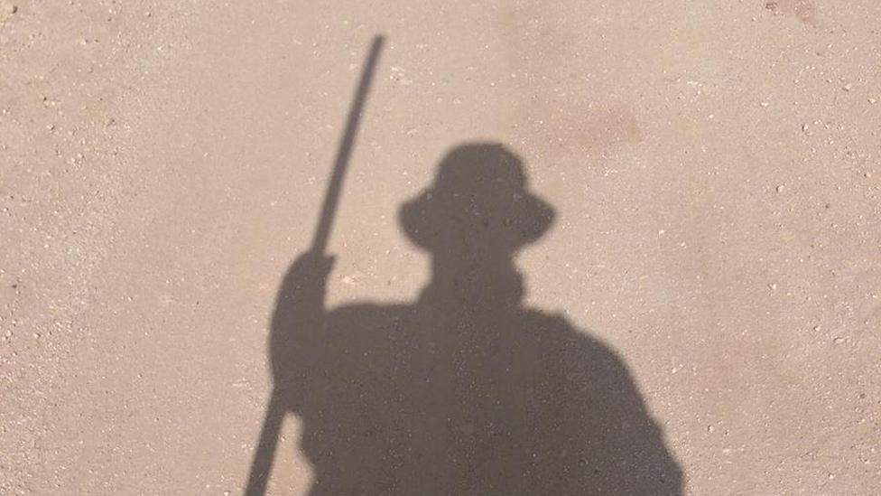 Bob's shadow on the dusty ground