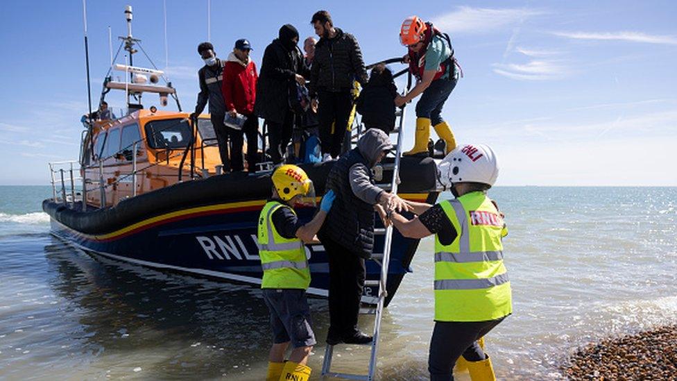 Families are helped ashore by the RNLI after being rescued in the English Channel