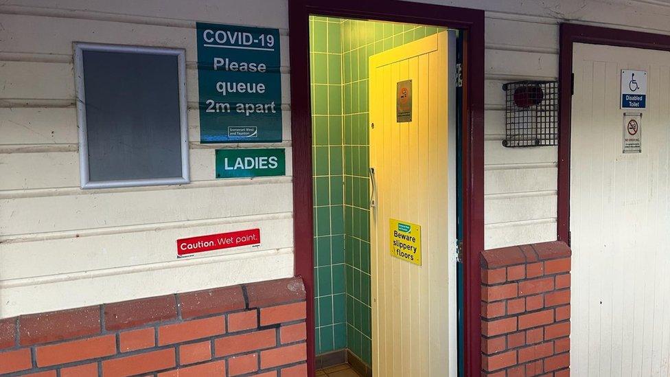 Wooden toilet doors in a brick and wood wall in Taunton in Somerset