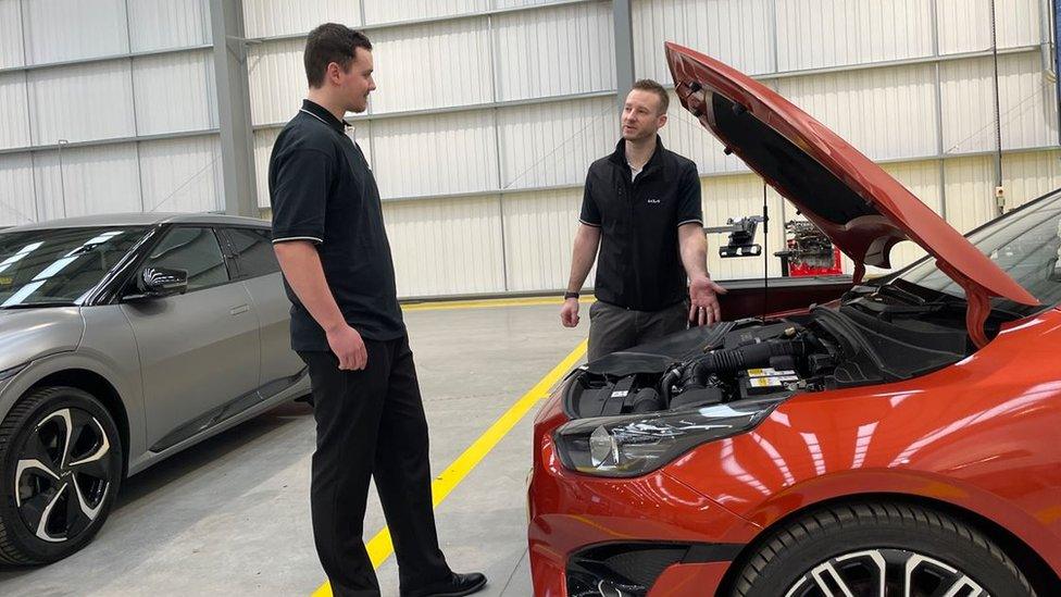 Apprentice Balazs Bekesi looks under the hood