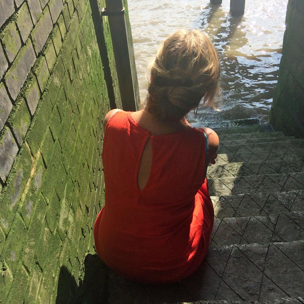 Sue sitting by the river