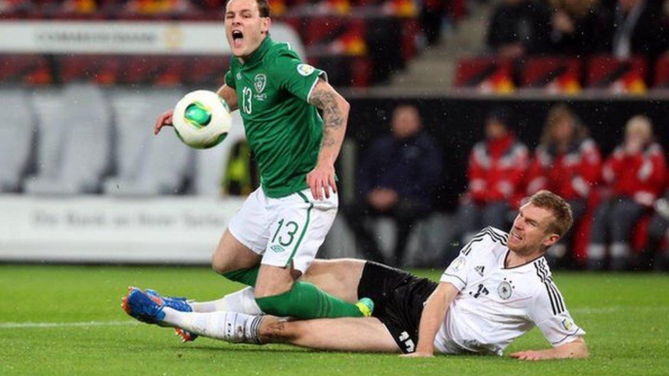 Anthony Stokes is tackled by Germany's Per Mertesacker