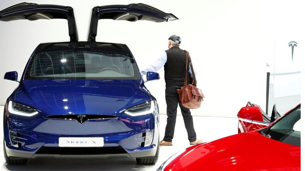 A visitor inspects a Tesla Model X electric vehicle at Brussels Motor Show, Belgium, January 18, 2019.