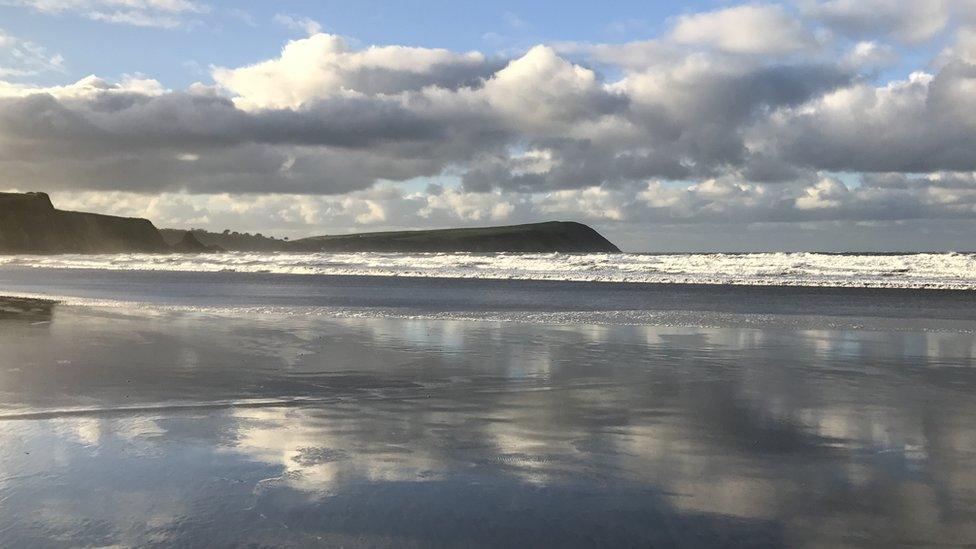 Crashing waves and a blustery sky at Newport Beach, Pembrokeshire