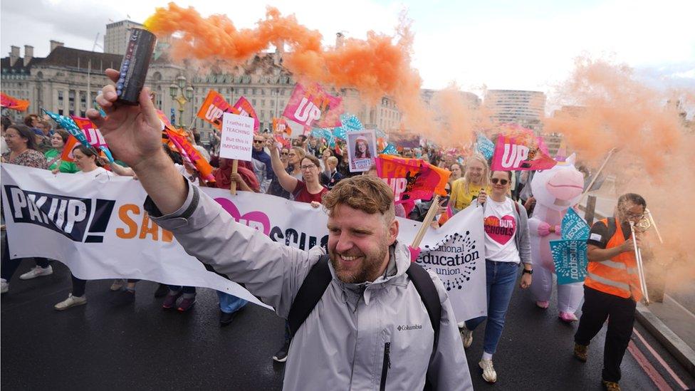 Members of the National Education Union (NEU) take part in a rally through Westminster to Parliament Square, London, in July this year