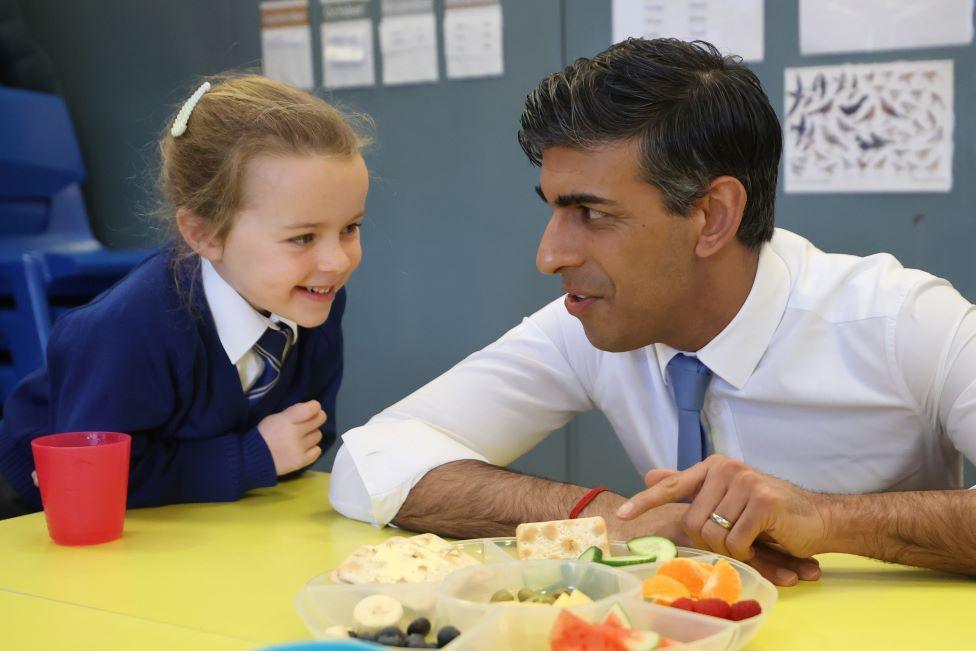 Rishi Sunak speaking to primary 2 students as they take their healthy break during his visit to Glencraig Integrated Primary School in Holywood, Co Down.