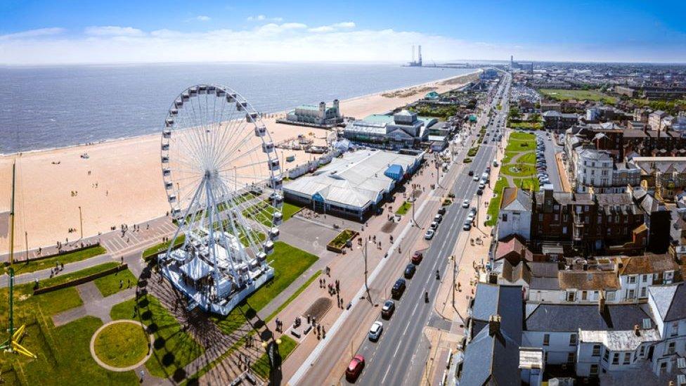 Great Yarmouth seafront. You can see a Ferris wheel, the beach and surrounding buildings