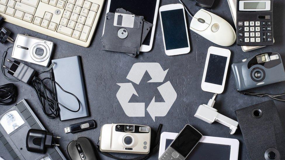 Mobiles phones, cameras and electronical items and the recycling logo