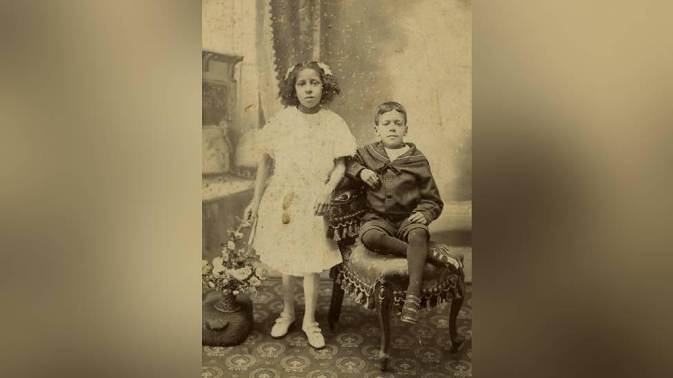 An old photograph of a young boy and girl