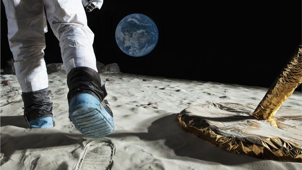 astronaut walking on the moon