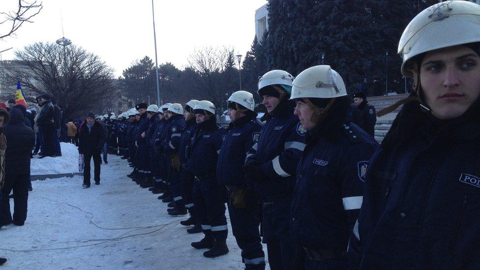 Police form a line in Chisinau to prevent protesters from moving closer