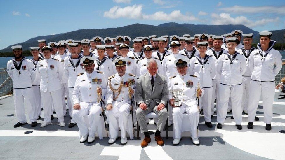 Prince Charles poses for photos with the crew of HMAS Melville during his visit to HMAS Cairns