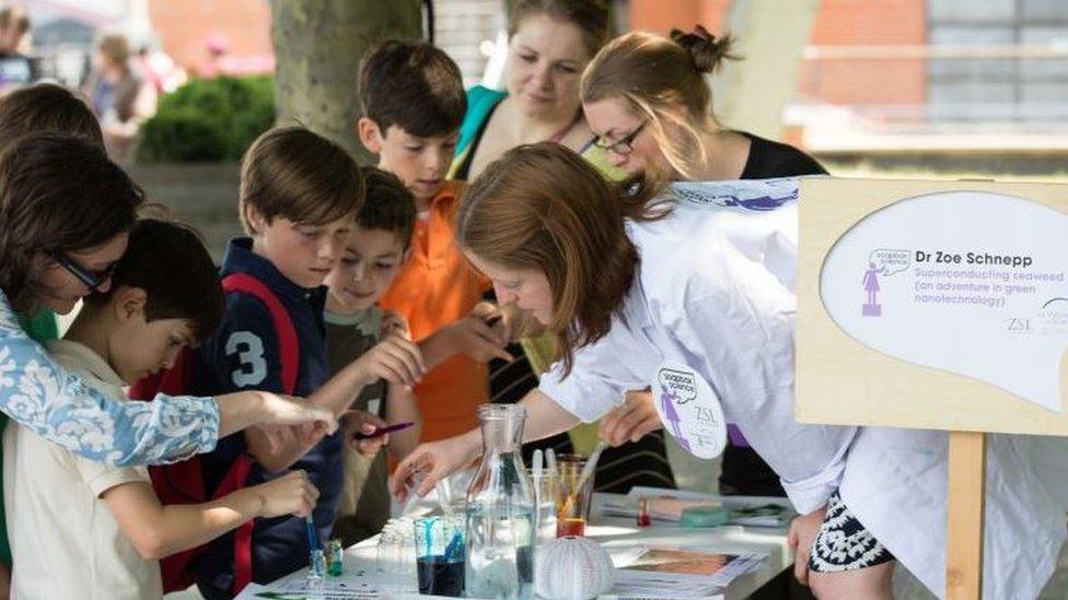 A scientist gives children a Soapbox Science demonstration