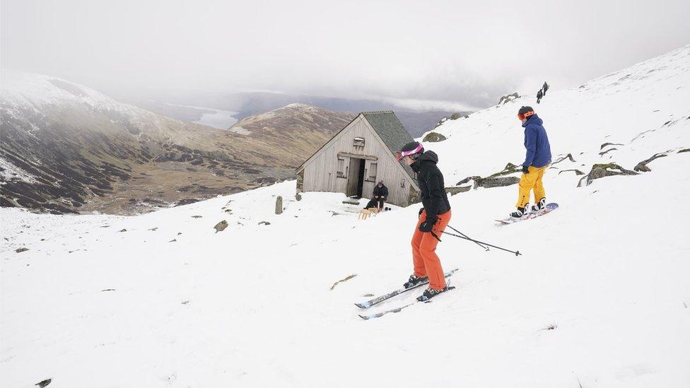 Skiers makes their way down the slope at the Lake District Ski Club on Raise, next to Helvellyn in the Lake District National Park