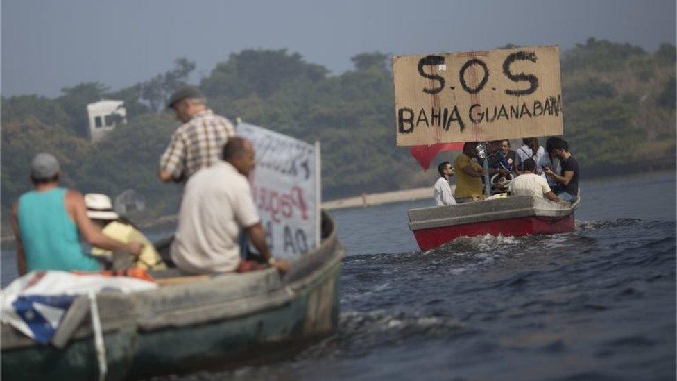 Fishermen protest against the pollution in the Guanabara bay, in Rio de Janeiro, Brazil, Sunday, July 3, 2016.