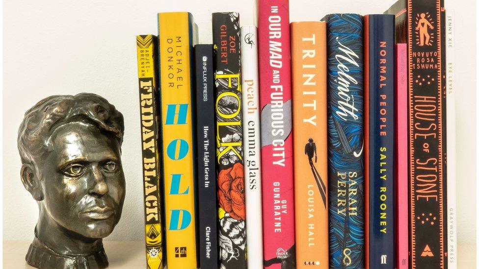 A model of Dylan Thomas with the 12 books