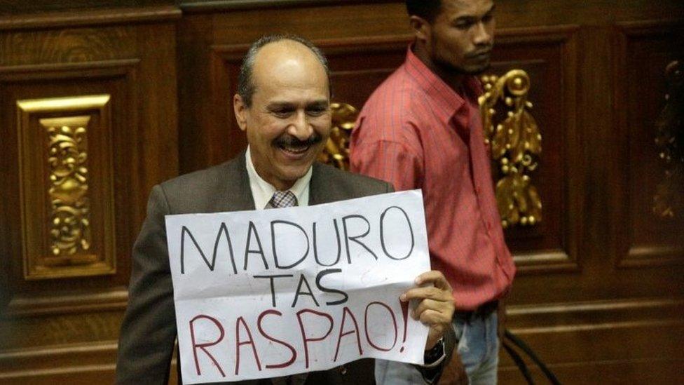 A deputy of the Venezuelan coalition of opposition parties (MUD) holds a placard that reads "Maduro you have failed" during a session of the National Assembly in Caracas, Venezuela January 9, 2017