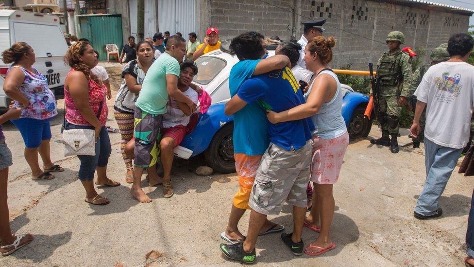 Relatives of five people murdered on a street cry in Acapulco's Icacos neighbourhood, Guerrero State, Mexico, on 17 April, 2016