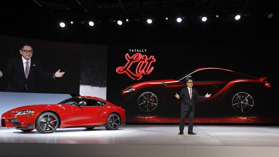 Akio Toyoda, President of Toyota Motor Corporation, stands with The 2020 Toyota Supra rear-wheel-drive sports coupe at its reveal at the 2019 North American International Auto Show during Media preview days on January 14, 2019 in Detroit, Michigan