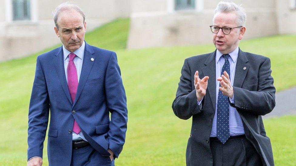 Ireland's Prime Minister Michael Martin (L) talks with Britain's Chancellor of the Duchy of Lancaster Michael Gove after a meeting of the British-Irish Council at the Lough Erne Resort in Enniskillen, Northern Ireland on June 11, 2021.