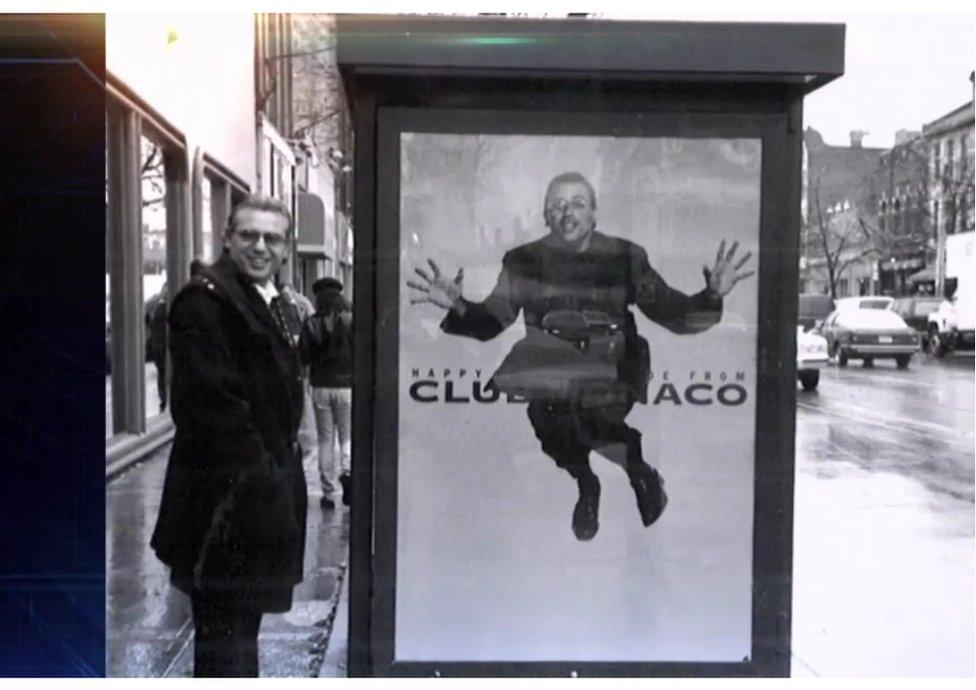 Joe Mimran next to an advert for Club Monaco