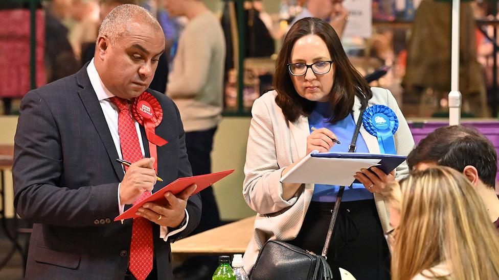 Members of the Labour and Conservative parties observe as ballots are counted