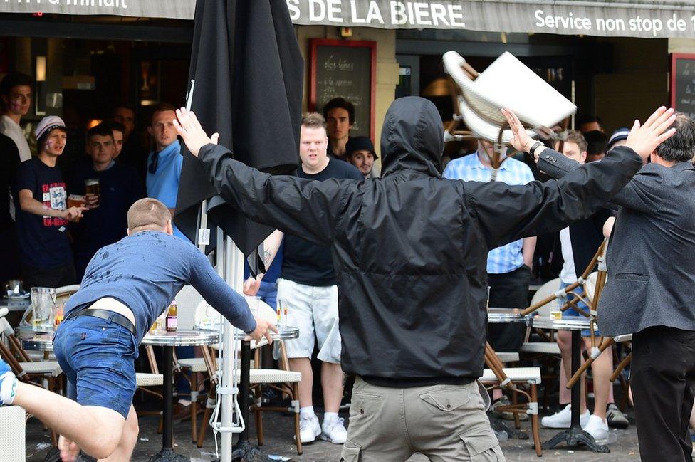 Russian football fans confront England fans at a cafe in Lille, 14 Jun 16