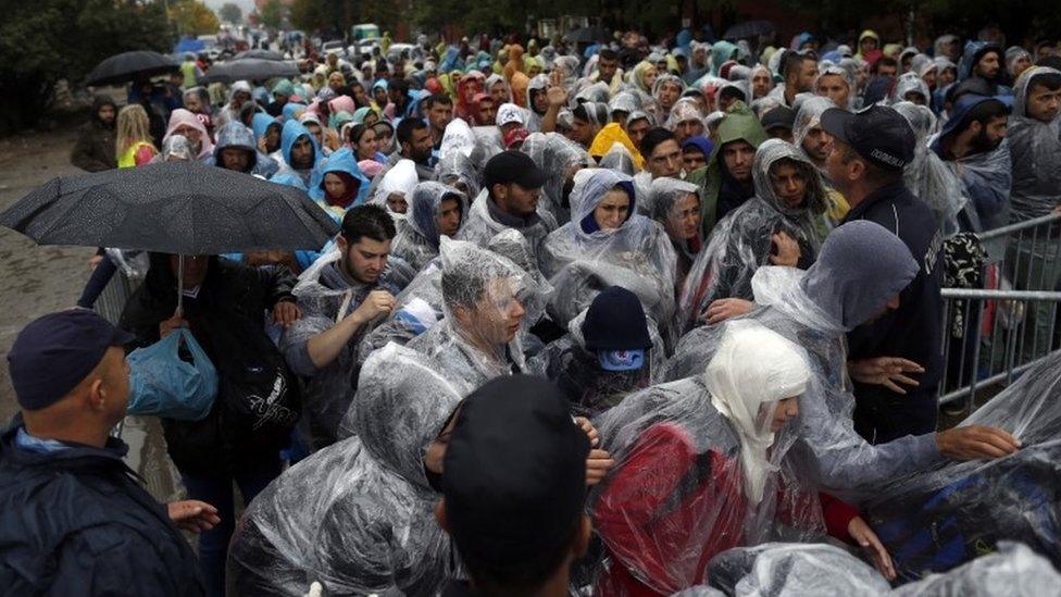 Police try to control the crowd as migrants enter to registration centre in the southern Serbian town of Presevo, 7 Oct 2015