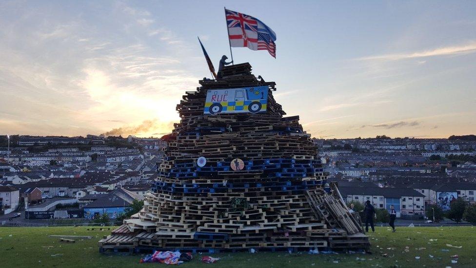 Flags were places on the bonfire near the city walls on Tuesday night