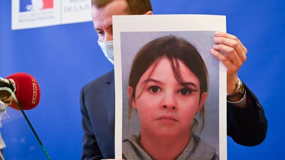 French public prosecutor Nicolas Heitz holds a portrait of missing child Mia Montemaggi during a press conference at The Epinal Courthouse in Epinal, eastern France on April 14, 2021