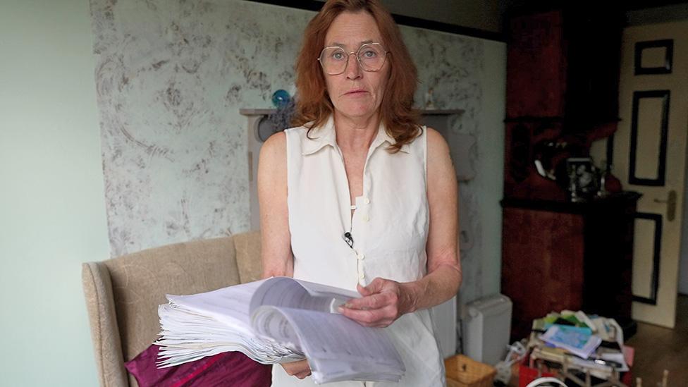 Nancy Crow with a huge pile of documents to do with her benefit claims