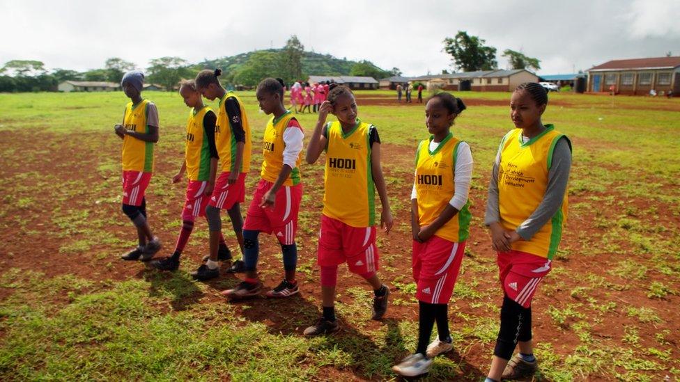 Seven girls on a football pitch