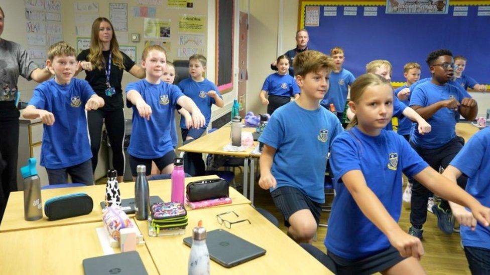 Children exercising in a classroom