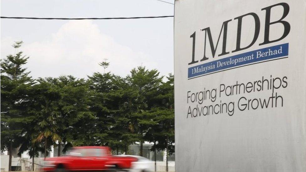 Traffic passes a 1Malaysia Development Berhad (1MDB) billboard at the Tun Razak Exchange development in Kuala Lumpur, Malaysia, 6 July 2015