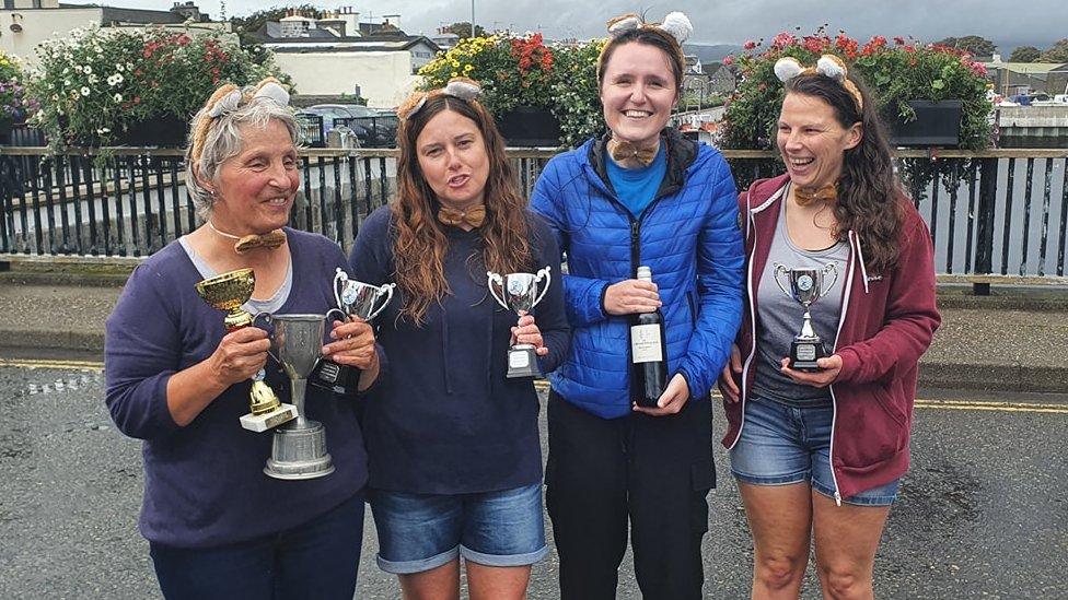 Winners in the women's race holding trophies