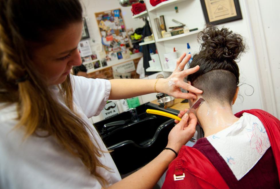 A woman having her neck shaved