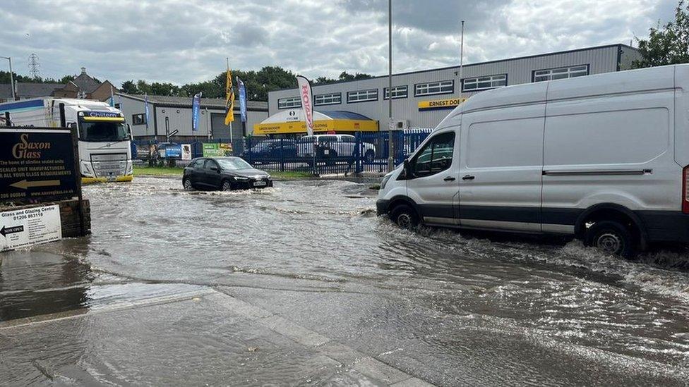 Vehicles tackle a flooded Haven Road, in Colchester