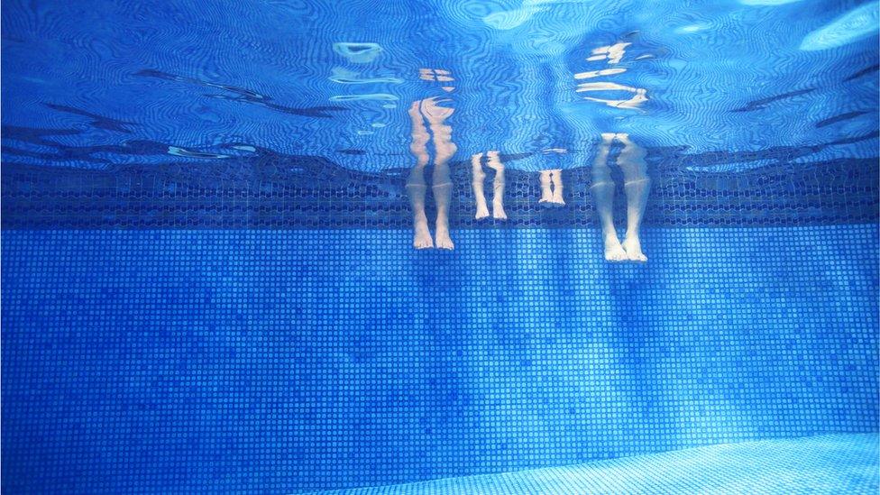 A family in a swimming pool