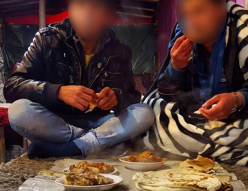 A taste of home: Migrants eating Afghan food in a makeshift cafe