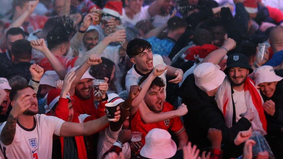 England fans cheering as England defeat Senegal in Croydon, London.