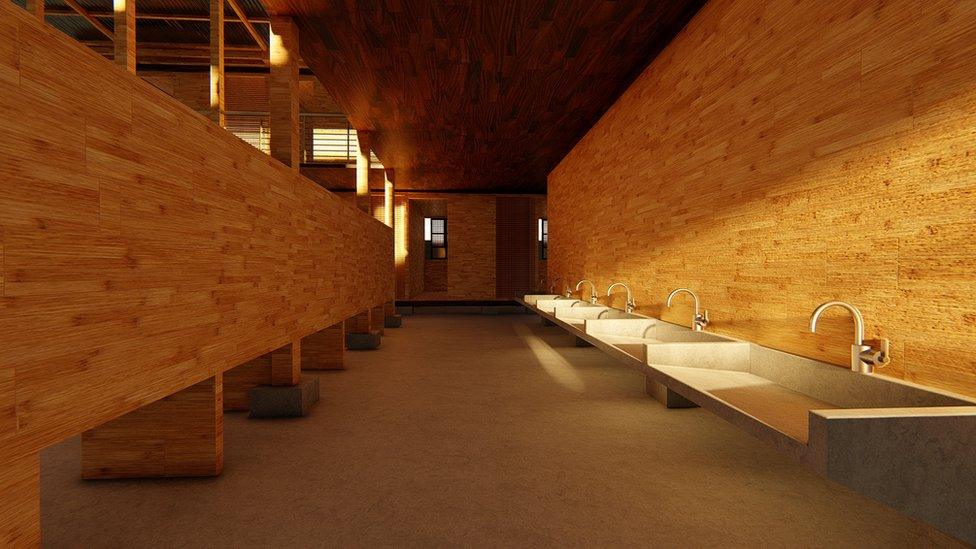 A row of sinks inside the house bathed in a golden glow as sunshine hits the bamboo walls