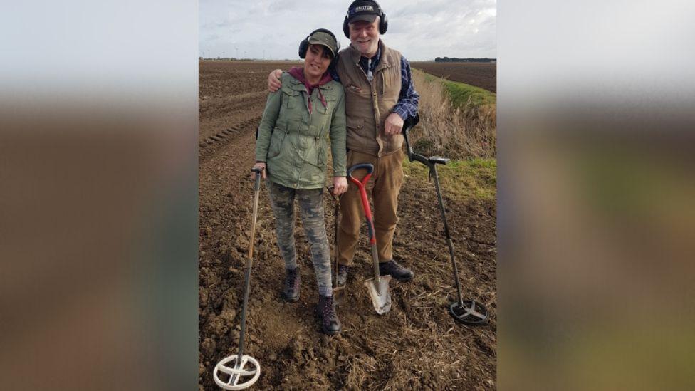 Paul Shepheard and wife Joanne in a field with metal detectors