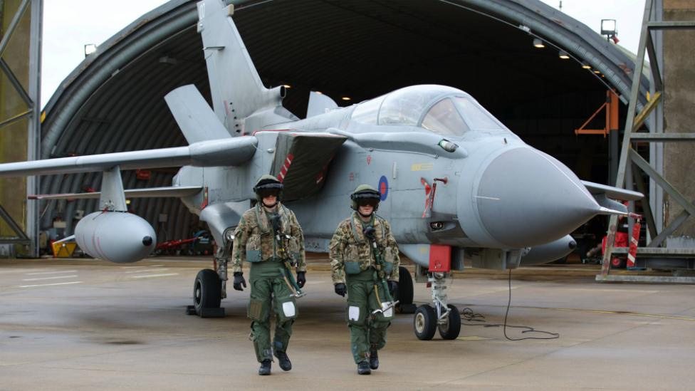 Pilots walk away from a Tornado fighter jet at RAF Marham in Norfolk, UK - 2 December 2015