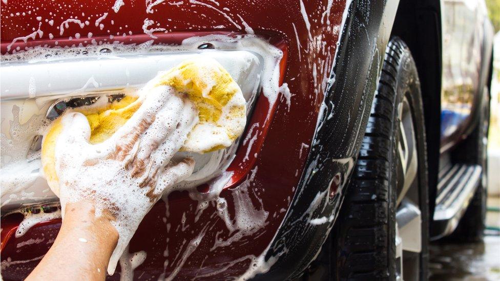 A person washing a car